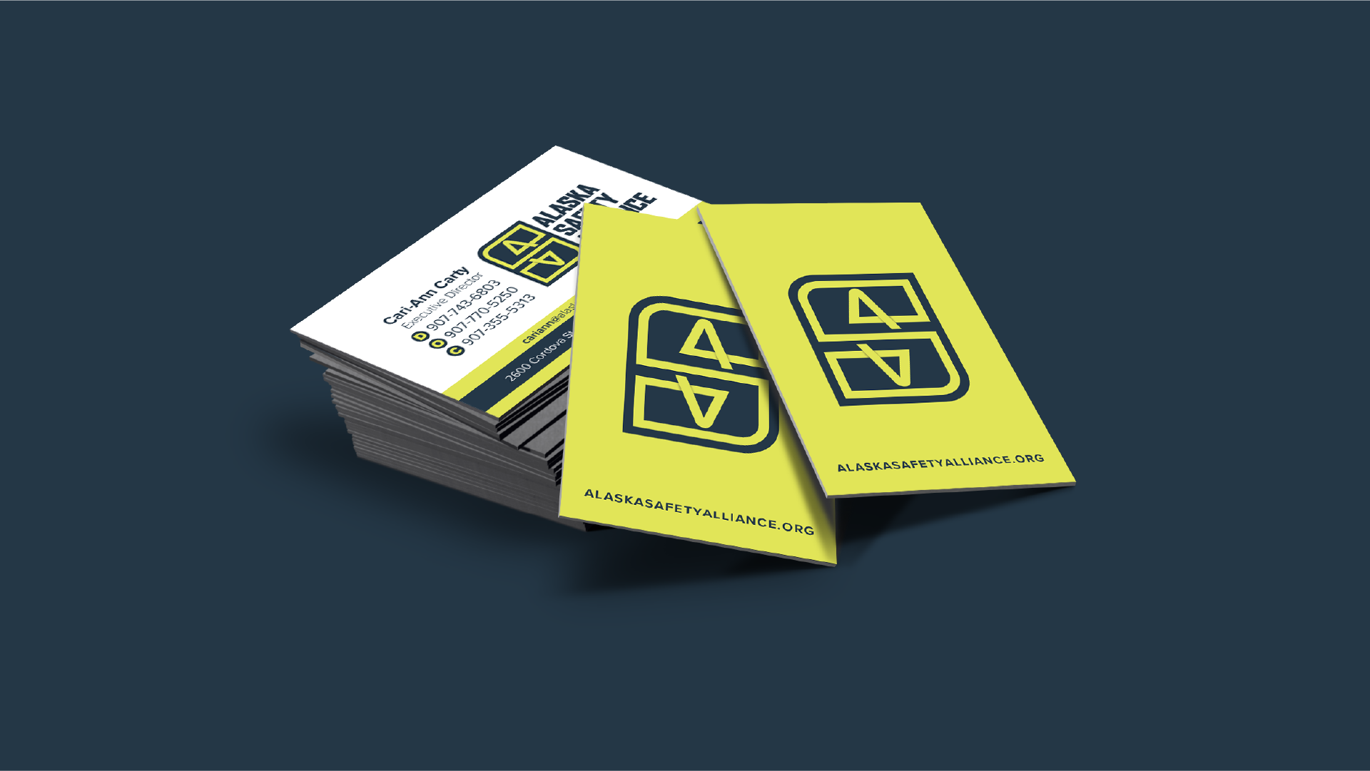 A bright green business card featuring the new logo in navy blue of the Alaska Safety Alliance.