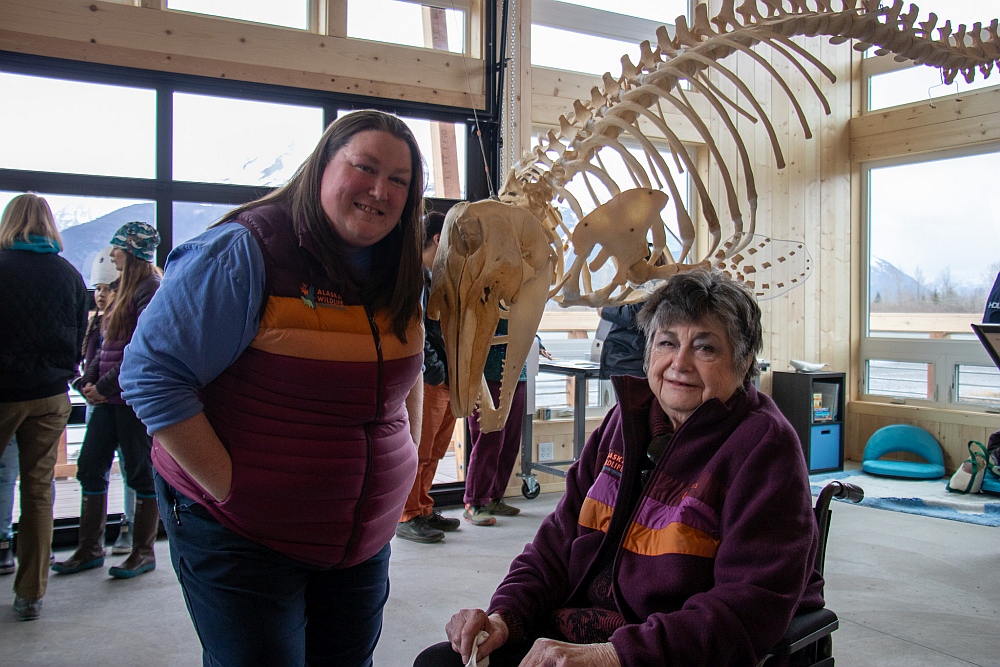 AWCC Executive Director Sarah Howard and MSI Senior Vice President Lana Johnson in the new Matson Ocean Education Center. A large beluga whale skeleton and the center windows are in the background.
